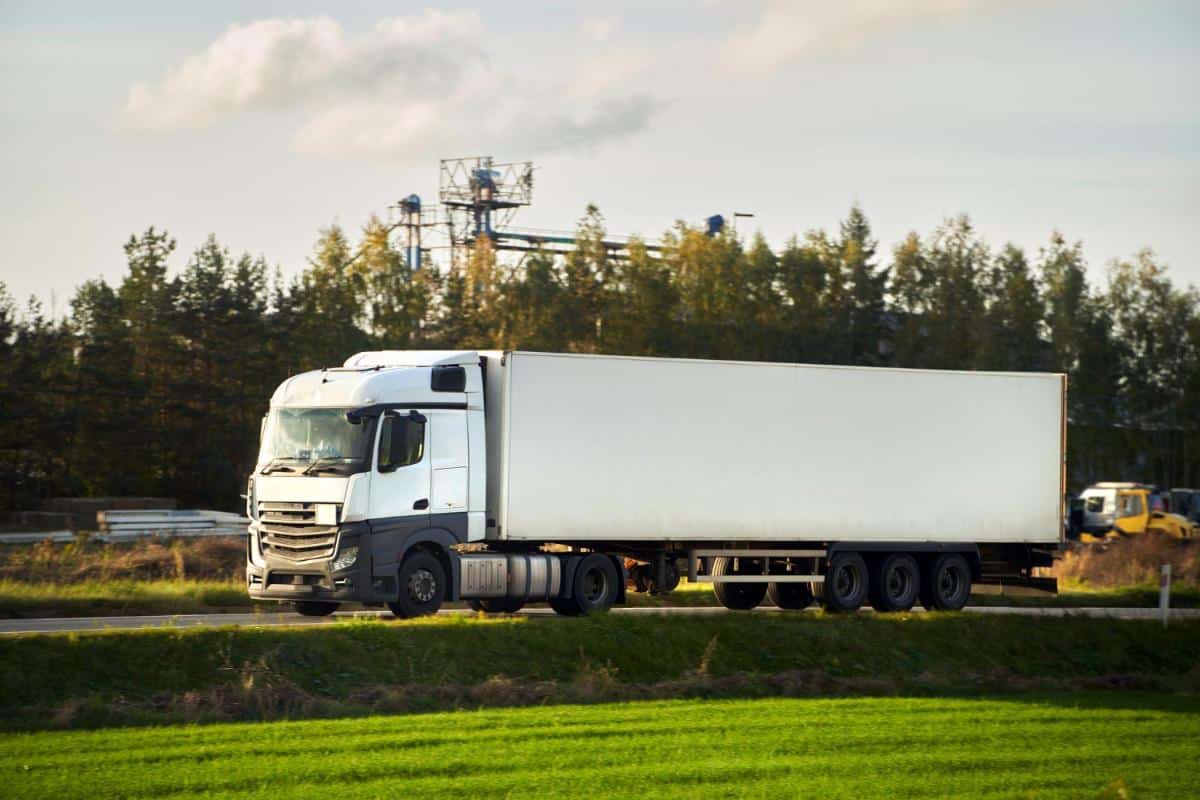 efficient ground shipping trucking through rural landscape shipping company branding mockup delivery truck countryside highway trucking europe